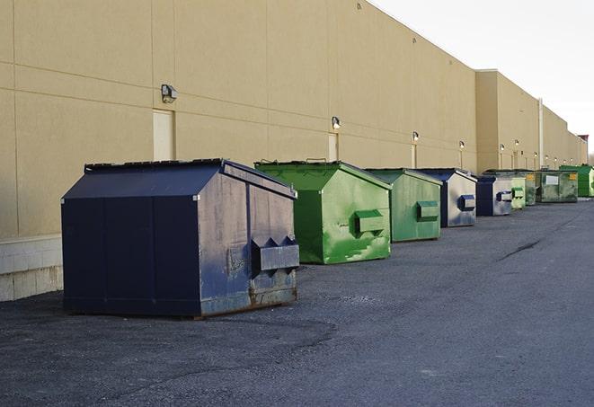 a construction worker disposing of debris into a dumpster in Apalachicola